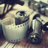 Old photo film rolls, cassette and retro camera. Vintage stylized.